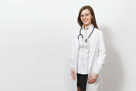 Smiling confident beautiful young doctor woman with stethoscope, glasses isolated on white background. Female doctor in medical gown looking camera. Healthcare personnel, health, medicine conceptの写真素材