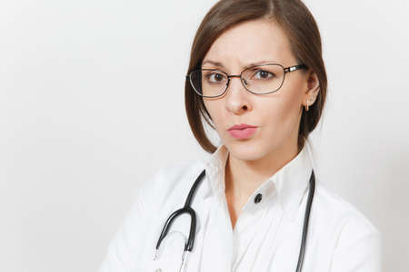 Close up skeptical sad brunette beautiful young doctor woman with stethoscope, glasses isolated on white background.の写真素材