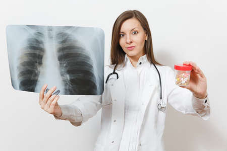 Doctor woman with bottle with pills, X-ray of lungs, fluorography, roentgen isolated on white background.の写真素材