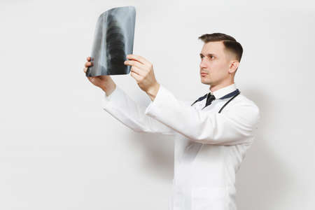 Perplexed focused doctor man with X-ray of lungs, fluorography, roentgen isolated on white...