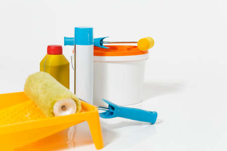 Instruments for renovation apartment room isolated on white background. Wallpaper and accessories for gluing, painting tools. Paint roller close up. Concept of repair home. Copy space advertisementの写真素材
