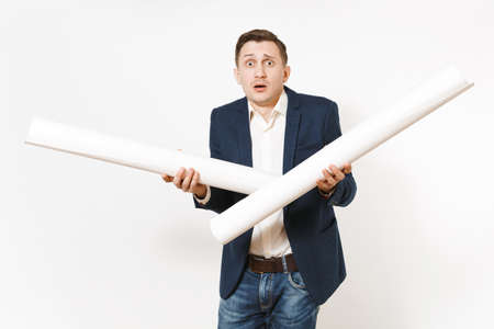 Young handsome successful concerned dissatisfied businessman in dark suit holding two blueprints...