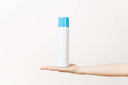 Close up of female hand horizontal holds empty spray bottle with copy space isolated on white...