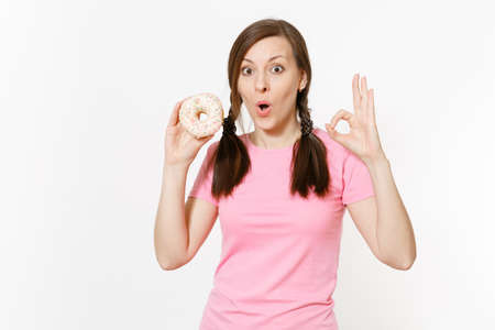 Beautiful fun happy woman holding in hands colorful donut isolated on white background. Proper nutrition or sweets, dessert fast food. dieting concept. Copy space for advertisement. Advertising areaの写真素材