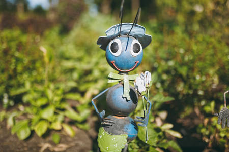 One decorative garden funny cute sweet ant in hat, bow tie with shovel in flower pot with cactus decorating yard.の写真素材