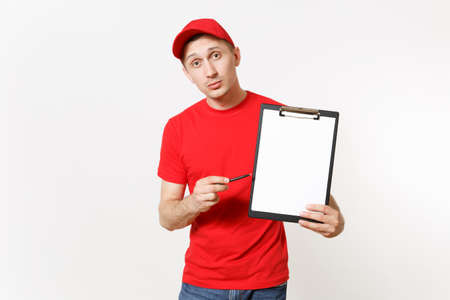 Delivery man in red uniform isolated on white background. Male in cap, t-shirt, jeans working as courier or dealer, holding pen, clipboard with papers document, with blank empty sheet. Copy spaceの写真素材