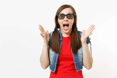 Portrait of young shocked scared woman with opened mouth in 3d glasses and casual clothes watching...