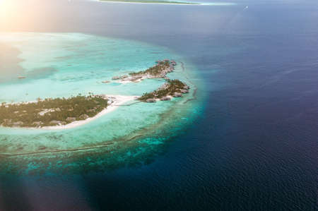 The tropical islands and atolls in Maldives in Indian Ocean from aerial view. Piece of paradise on the Earth. Good choice for vacation. Beautiful top view for wallpaper.の写真素材