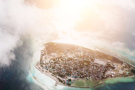 The tropical islands and atolls in Maldives in Indian Ocean from aerial view. Piece of paradise on the Earth. Good choice for vacation. Beautiful top view for wallpaper.の写真素材