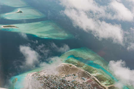 The tropical islands and atolls in Maldives in Indian Ocean from aerial view. Piece of paradise on the Earth. Good choice for vacation. Beautiful top view for wallpaper.の写真素材