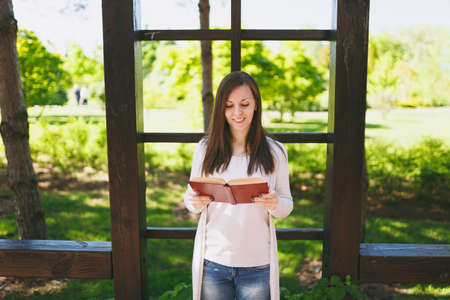 Portrait of beautiful calm peaceful young woman wearing light casual clothes relaxing, reading book....