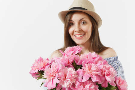 Close up young woman in dress, hat holding bouquet of beautiful pink peonies flowers isolated on white background. St. Valentine's Day, International Women's Day holiday concept. Advertising areaの写真素材