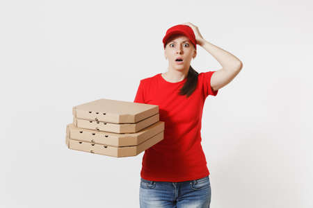 Woman in red cap, t-shirt giving food order pizza boxes isolated on white background. Female pizzaman working as courier or dealer holding italian pizza in cardboard flatbox. Delivery service conceptの写真素材