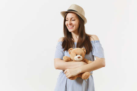 Young tender elegant charming woman dressed blue dress, cute hat with long brunette hair posing isolated on white background. People, sincere emotions, lifestyle concept. Advertising area. Copy spaceの写真素材