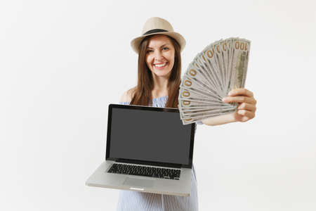 Woman holding modern laptop computer with blank black empty screen to copy space, bundle of dollars,...