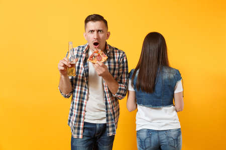Young cheerful couple supporter, woman man, football fans cheer up support team, holding beer...