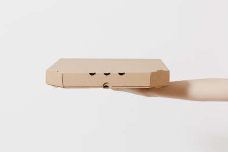 Close up female holds in hand italian pizza in clear empty blank cardboard flatbox, food order pizza...