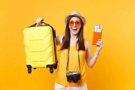 Traveler tourist woman in summer casual clothes, hat with suitcase, passport ticket isolated on...