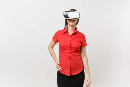Portrait of young smart business woman in red shirt, black skirt in headset of virtual reality on...
