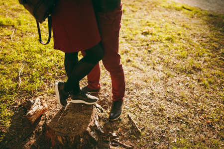 Cropped image Young couple woman, man in burgundy clothes female, male legs hugging embracing...