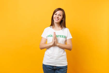 Portrait of happy smiling satisfied woman in white t-shirt with written inscription green title...