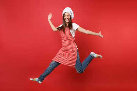 Housewife female chef cook or baker in striped apron white t-shirt, toque chefs hat isolated on red...