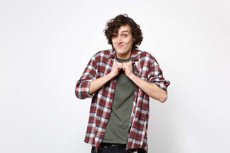 Portrait of funny smiling young man in casual clothes looking camera and clenching fists isolated on white wall background in studio. People sincere emotions lifestyle concept. Mock up copy spaceの写真素材