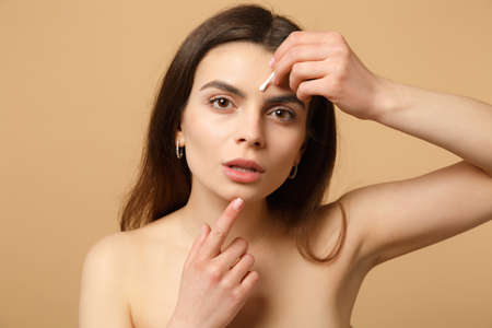 Close up brunette half naked woman 20s with perfect skin, nude make up isolated on beige pastel wall background, studio portrait. Skin care healthcare cosmetic procedures concept. Mock up copy spaceの写真素材