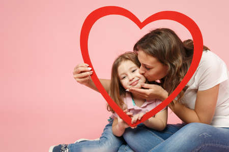Woman in light clothes have fun with cute child baby girl. Mother, little kid daughter isolated on...
