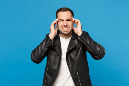 Young sad frustrated worried unshaven man in black jacket white t-shirt looking camera isolated on...