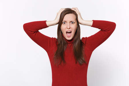 Shocked bewildered young brunette woman girl in casual red clothes posing isolated on white...