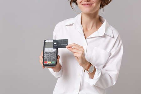 Cropped image of young business woman in white shirt isolated on grey background. Achievement career...