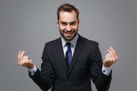 Smiling business man in classic suit shirt tie posing isolated on grey background. Achievement...
