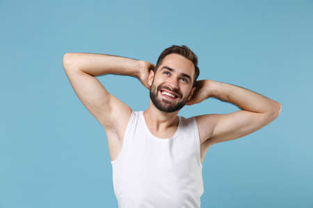 Close up bearded young man 20s years old perfect skin wearing white shirt isolated on blue pastel wall background, studio portrait. Skin care healthcare cosmetic procedures concept. Mock up copy spaceの写真素材