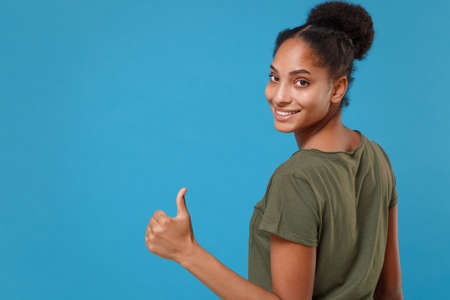 Back rear view of smiling young african american woman girl in casual t-shirt posing isolated on...