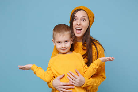 Woman in yellow clothes have fun posing with cute child baby boy 4-5 years old. Mommy little kid son...