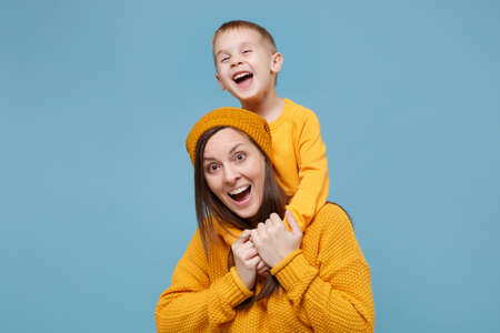 Woman in yellow clothes have fun posing with cute child baby boy 4-5 years old. Mommy little kid son...