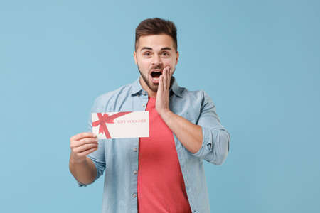 Shocked young bearded guy 20s in casual shirt posing isolated on pastel blue wall background studio...
