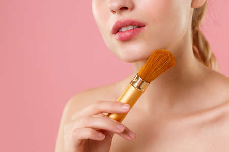 Close up blonde half naked woman 20s perfect skin nude make up blue eyes isolated on pastel pink wall background studio portrait. Skin care healthcare procedures concept. Mock up copy space Brush faceの写真素材