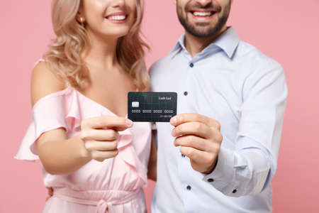 Cropped image of smiling young couple two guy girl in party outfit celebrating posing isolated on...