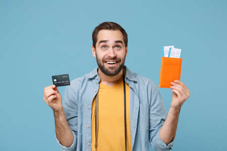 Smiling traveler tourist man in summer clothes with photo camera isolated on blue background....