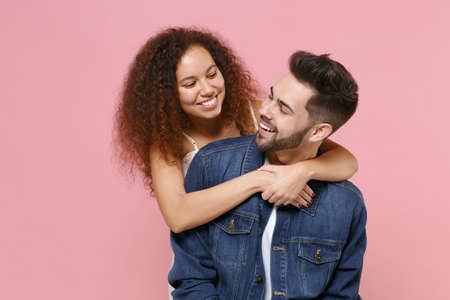 Funny young couple two friends european guy african american girl in casual clothes isolated on...