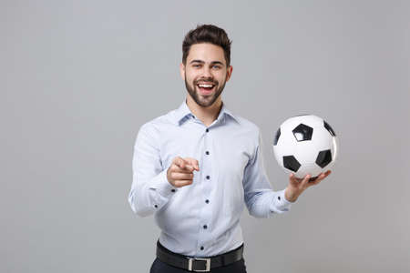 Funny business man football fan in light shirt isolated on grey background. Achievement career sport...