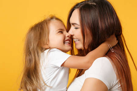 Woman in light clothes have fun with cute child baby girl 4-5 years old. Mommy little kid daughter...