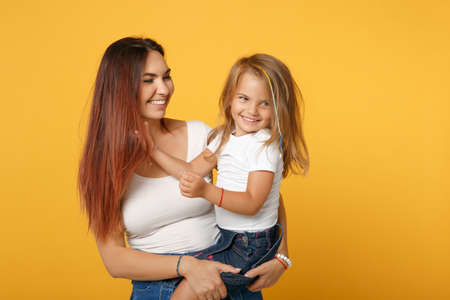 Woman in light clothes have fun with cute child baby girl 4-5 years old. Mommy little kid daughter...