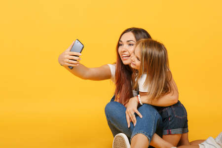Woman in light clothes doing selfie with cute child baby girl 4-5 years old. Mommy little kid...