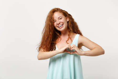 Young joyful redhead woman in casual light clothes posing isolated on white background. People...