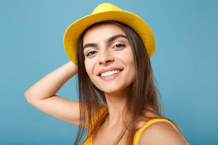 Close up shot traveler tourist woman in yellow summer casual clothes hat doing selfie on mobile phone posing isolated on blue wall background studio portrait. People lifestyle concept. Looking camera.の写真素材