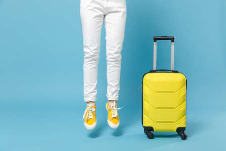 Traveler tourist woman in yellow casual clothes, hat with suitcase photo camera isolated on blue...
