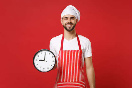 Smiling young bearded male chef cook or baker man in striped apron white t-shirt toque chefs hat...